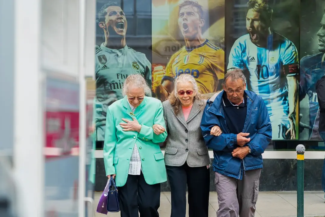 two women and man walking